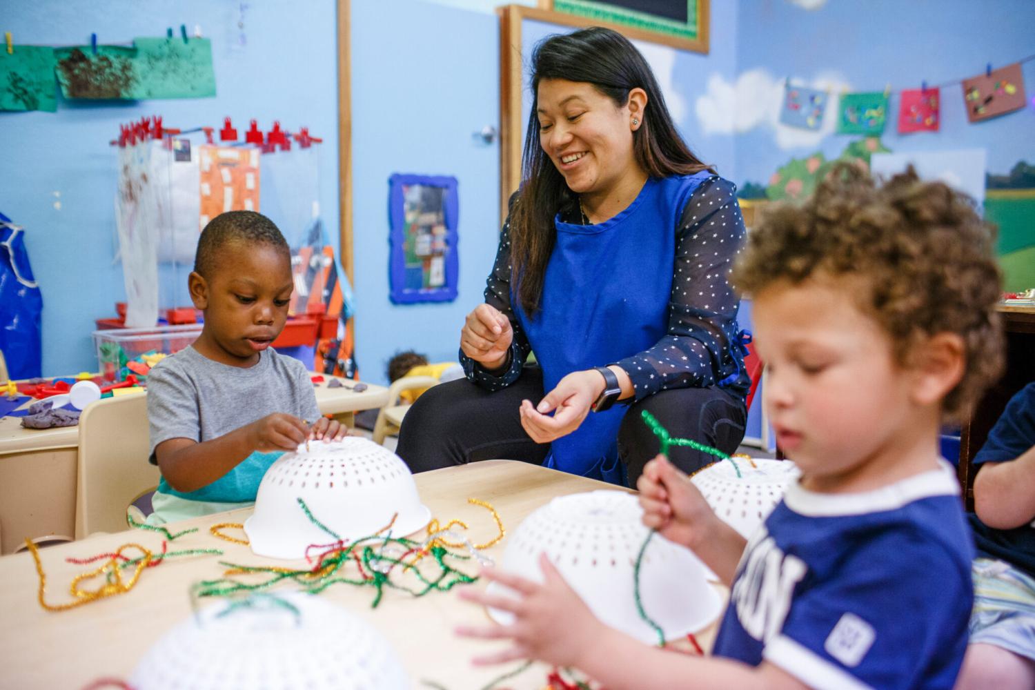 Early education student working with two preschool students