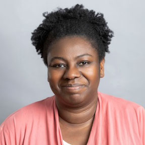 Headshot of Ruth Ayodeji smiling at the camera, wearing a pink shirt.